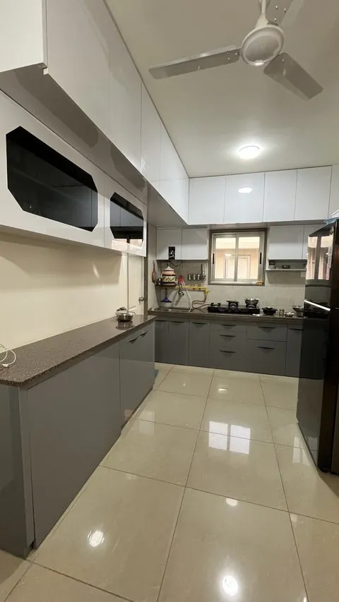 Grey and white PVC modular kitchen running the length of the room - Shree Krushn PVC Furniture, Nikol, Ahmedabad