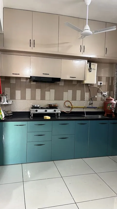 Teal and cream PVC modular kitchen with a granite counter and chimney - Shree Krushn PVC Furniture, Nikol, Ahmedabad