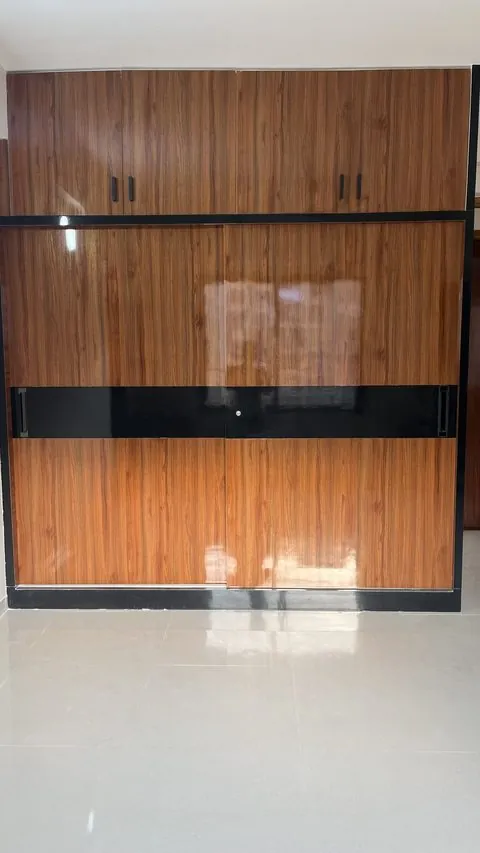 Walnut PVC sliding wardrobe with a black inlay band and loft cabinets - Shree Krushn PVC Furniture, Nikol, Ahmedabad