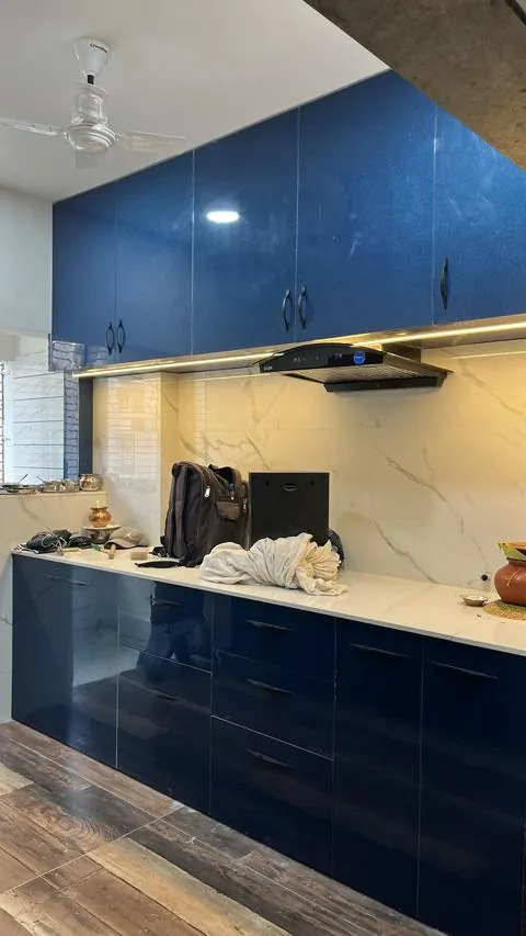 Royal blue high gloss PVC modular kitchen with a marble backsplash and profile light - Shree Krushn PVC Furniture, Nikol, Ahmedabad